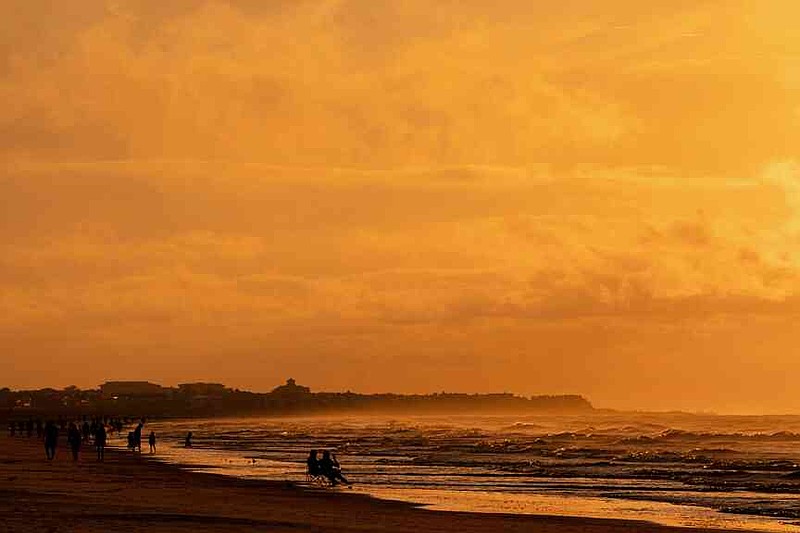 FILE - The sun rises over Isle of Palms, S.C., Aug. 13, 2022. (AP Photo/Julia Nikhinson, File)
