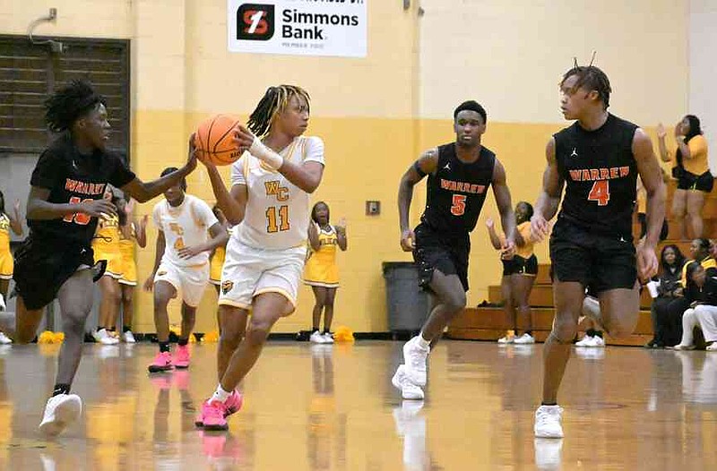 Jayden Green (11) of Watson Chapel looks to make an outlet pass as Kaystean Jacobs (10), Zaydin Grider (5) and Josiah Steen (4) of Warren surround him in the first half Friday, Feb. 6, 2026, at Leslie Henderson Gymnasium. (Pine Bluff Commercial/I.C. Murrell)