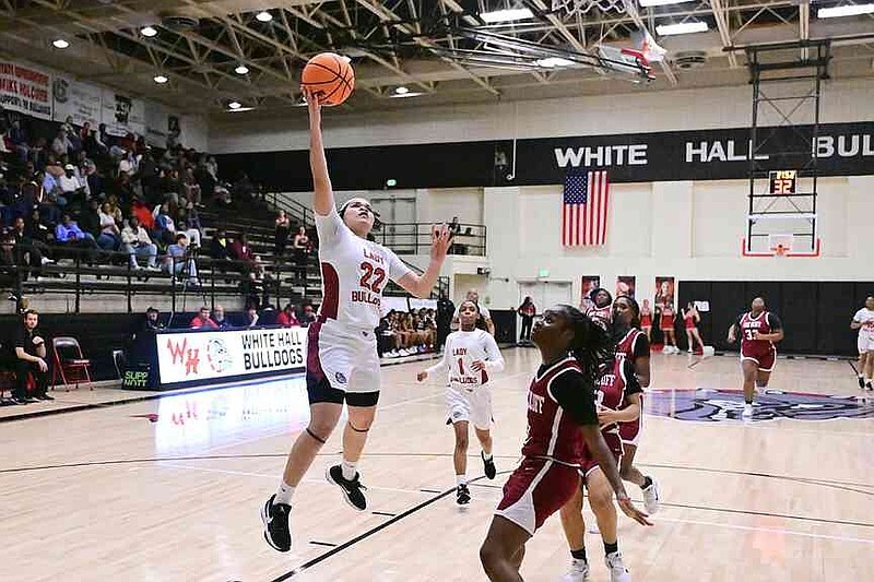 White Hall senior Kynnedi Barnett attempts a layup as Pine Bluff senior Adrianna McAfee looks on. (Special to the Commercial/William Harvey)