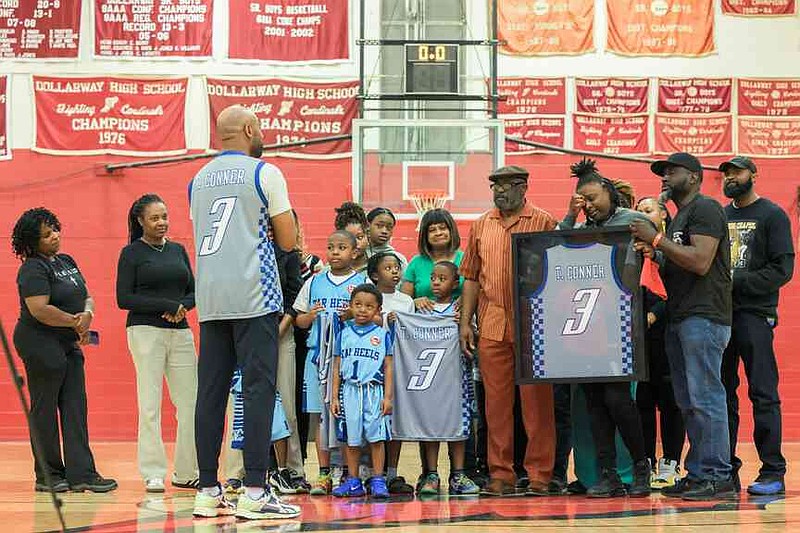 Lakesha Thomas, the mother of the late Taariq Conner, and her family are honored with a framed jersey in Conner's memory. (Special to The Commercial/Nicole Mealing)