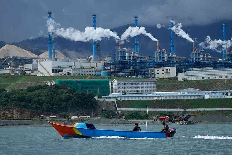 FILE - A boat cruises past a nickel processing plant at Indonesia Weda Bay Industrial Park in Central Halmahera, North Maluku province, Indonesia, June 8, 2024. (AP Photo/Achmad Ibrahim, File)