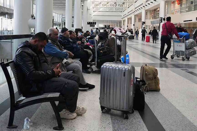 Passengers whose flights were cancelled, wait at the departure terminal of Rafik Hariri International Airport in Beirut, Lebanon, Saturday, Feb. 28, 2026, as many airlines canceled flights due to the conflict involving the United States, Israel and Iran. (AP Photo/Hassan Ammar)