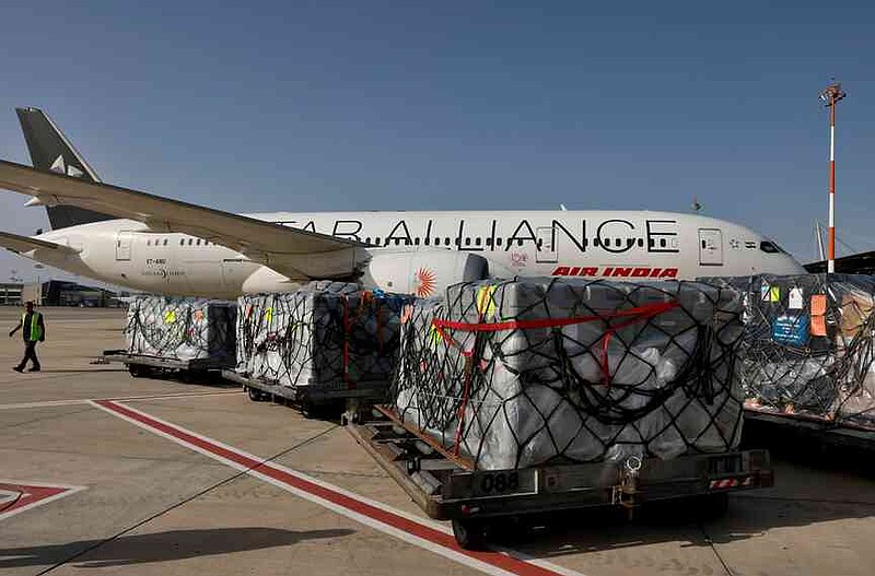 FILE -Workers load medical aid onto an Air India plane to be flown to India, at Ben Gurion Airport near Tel Aviv, Israel, May 4, 2021. (Menahem Kahana/Pool Photo via AP, File)