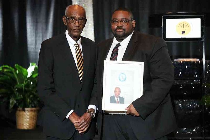 The Boys and Girls Club of Jefferson County honored Booker Clemons, left, with an award. Boys and Girls Club CEO Tavante Calhoun, made the presentation. Clemons has served the community in numerous capacities including a state representative and appointed Jefferson County judge. (Special to The Commercial/The Heat Magazine)