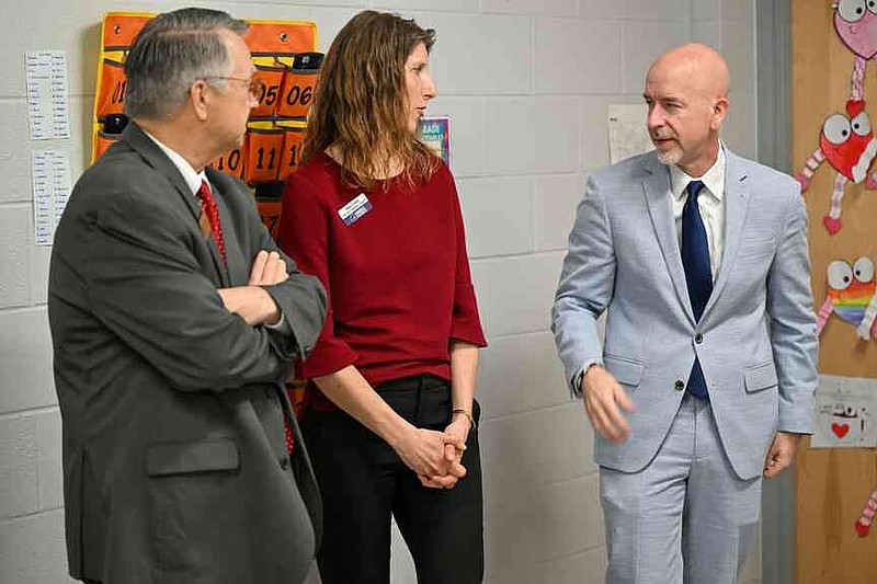 Charles Lee (from left), Rogers Public Schools assistant superintendent for secondary education, and Dana Finne, Oakdale Middle School instructional coach, speak with Arkansas Department of Education Secretary Jacob Oliva Wednesday during a classroom tour at Oakdale Middle School in Rogers. Oliva, Ken Warden, commissioner of the Arkansas Division of Higher Education, and Joel Rose, co-founder and chief executive officer of New Classrooms, visited Oakdale Elementary to view the implementation of New Classrooms program Teach to One Roadmaps, a digital math teaching tool that allows students to work through math concepts at their own pace. Visit nwaonline.com/photo for today's photo gallery.  (NWA Democrat-Gazette/Caleb Grieger)