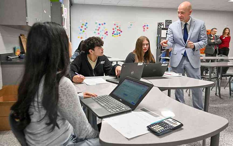 Arkansas Department of Education Secretary Jacob Oliva  watches eighth-grade students work with math program Teach to One Roadmaps Wednesday during a classroom tour at Oakdale Middle School in Rogers. Oliva, Ken Warden, commissioner of the Arkansas Division of Higher Education, and Joel Rose, co-founder and chief executive officer of New Classrooms, visited Oakdale Elementary to view the implementation of New Classrooms program Teach to One Roadmaps, a digital math teaching tool that allows students to work through math concepts at their own pace. Visit nwaonline.com/photo for today's photo gallery.  (NWA Democrat-Gazette/Caleb Grieger)