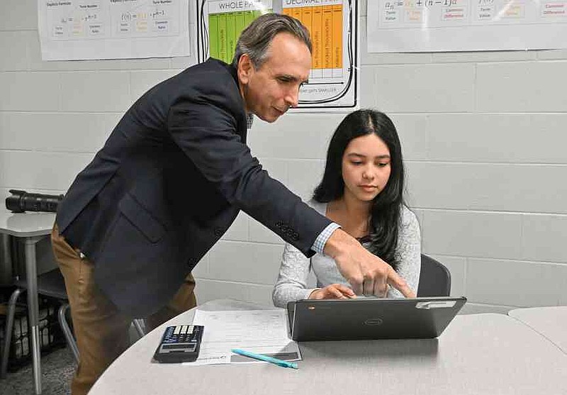 Joel Rose, co-founder and chief executive officer of New Classrooms, watches an eighth-grade student work with math program Teach to One Roadmaps Wednesday, March 11, 2026, during a classroom tour at Oakdale Middle School in Rogers. Arkansas Department of Education Secretary Jacob Oliva, Ken Warden, commissioner of the Arkansas Division of Higher Education, and Rose visited Oakdale Elementary to view the implementation of New Classrooms program Teach to One Roadmaps, a digital math teaching tool that allows students to work through math concepts at their own pace. Visit nwaonline.com/photo for today's photo gallery.  (NWA Democrat-Gazette/Caleb Grieger)