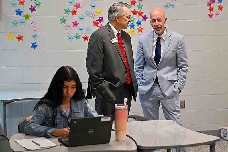 Charles Lee (second from left), Rogers Public Schools assistant superintendent for secondary education, speaks with Arkansas Department of Education Secretary Jacob Oliva Wednesday during a classroom tour at Oakdale Middle School in Rogers. Oliva, Ken Warden, commissioner of the Arkansas Division of Higher Education, and Joel Rose, co-founder and chief executive officer of New Classrooms, visited Oakdale Elementary to view the implementation of New Classrooms program Teach to One Roadmaps, a digital math teaching tool that allows students to work through math concepts at their own pace. Visit nwaonline.com/photo for today's photo gallery.  (NWA Democrat-Gazette/Caleb Grieger)