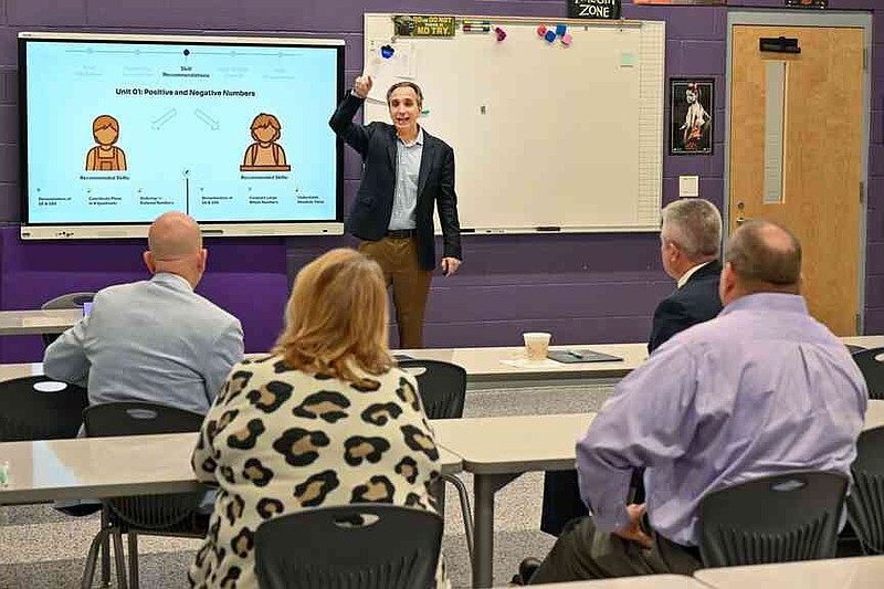 Joel Rose, co-founder and chief executive officer of New Classrooms, speaks Wednesday during a classroom tour at Oakdale Middle School in Rogers. Arkansas Department of Education Secretary Jacob Oliva, Ken Warden, commissioner of the Arkansas Division of Higher Education, and Rose visited Oakdale Elementary to view the implementation of New Classrooms program Teach to One Roadmaps, a digital math teaching tool that allows students to work through math concepts at their own pace. Visit nwaonline.com/photo for today's photo gallery.  (NWA Democrat-Gazette/Caleb Grieger)