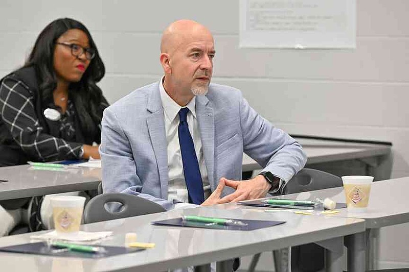 Arkansas Department of Education Secretary Jacob Oliva listens Wednesday during a classroom tour at Oakdale Middle School in Rogers. Oliva, Ken Warden, commissioner of the Arkansas Division of Higher Education, and Joel Rose, co-founder and chief executive officer of New Classrooms, visited Oakdale Elementary to view the implementation of New Classrooms program Teach to One Roadmaps, a digital math teaching tool that allows students to work through math concepts at their own pace. Visit nwaonline.com/photo for today's photo gallery.  (NWA Democrat-Gazette/Caleb Grieger)
