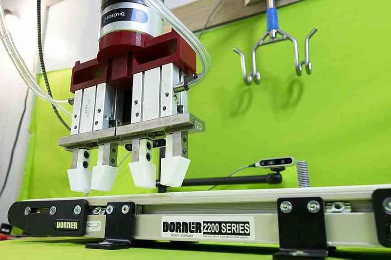 The autonomous robotic arm was programmed with imitation learning, trained by a human, to move a chicken carcass onto a shackle conveyor for further processing while adjusting to challenges. (Special to The Commercial/Paden Johnson/University of Arkansas System Division of Agriculture)