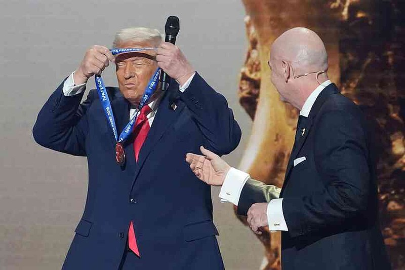 FILE - President Donald Trump is presented with the inaugural FIFA Peace Prize by FIFA President Gianni Infantino during the 2026 FIFA World Cup draw at the Kennedy Center, Dec. 5, 2025, in Washington. (AP Photo/Evan Vucci, file)