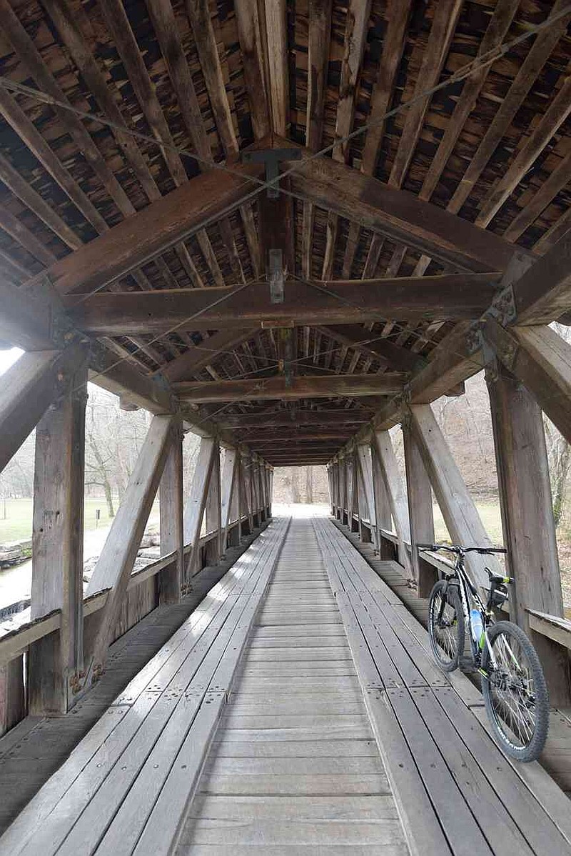 A wooden bridge built by Amish craftsman spans the stream at Dogwood ...