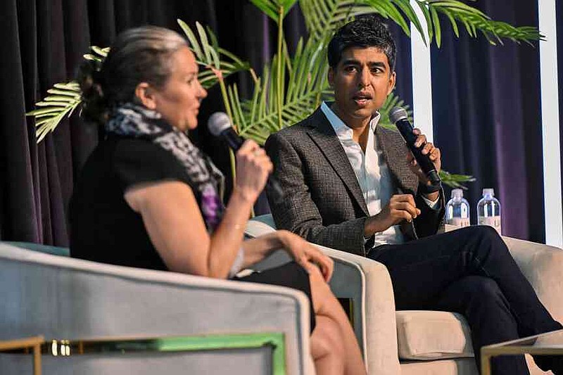 Cara Osborne (left) and keynote speaker Dr. Neel Shah, chief medical officer of Maven Clinic, speak Thursday during the Northwest Arkansas Health Summit at Fayetteville Town Center. Attendees of the Northwest Arkansas Health Summit heard from a variety of speakers to learn about strategies for improving health care throughout the state.  Visit nwaonline.com/photo for today's photo gallery.  (NWA Democrat-Gazette/Caleb Grieger)