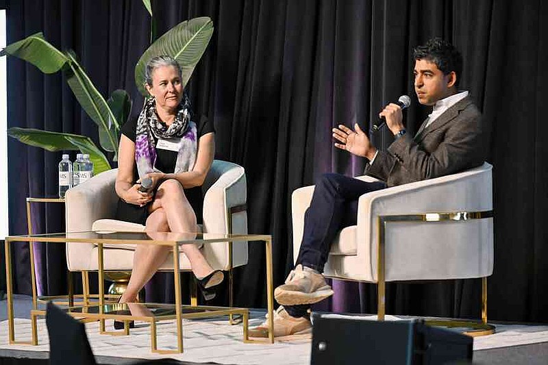 Cara Osborne (left) and keynote speaker Dr. Neel Shah, chief medical officer of Maven Clinic, speak Thursday during the Northwest Arkansas Health Summit at Fayetteville Town Center. Attendees of the Northwest Arkansas Health Summit heard from a variety of speakers to learn about strategies for improving health care throughout the state.  Visit nwaonline.com/photo for today's photo gallery.  (NWA Democrat-Gazette/Caleb Grieger)