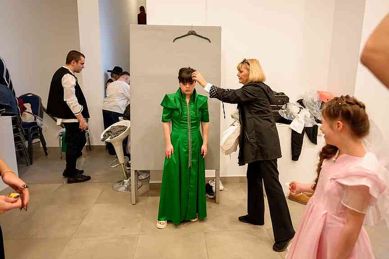 Andrada Placintescu stands before the SEEN Anonymous Seamstresses Gala, an event organised by the Down Plus Bucharest, an NGO supporting youngsters with Down Syndrome and other intellectual disabilities, in Bucharest, Romania, Wednesday, March 18, 2026, ahead of the World Down Syndrome Day, on March 21. (AP Photo/Andreea Alexandru)