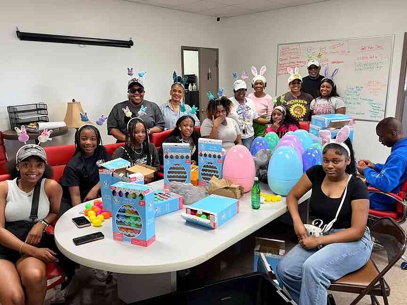 Parks and Recreation Director Prutty Holman and volunteers pose inside after packing kits and massive eggs for the Easter event. (Special to the Commercial)