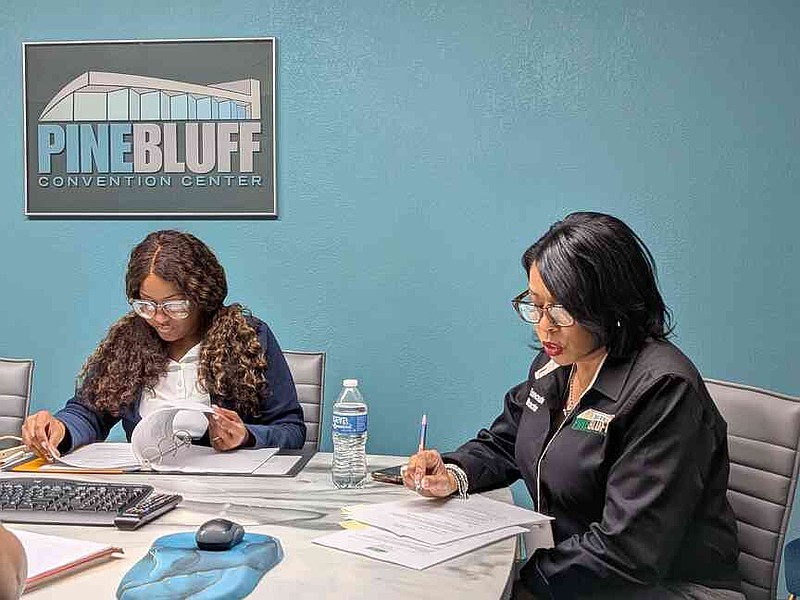 Barbara Dunn (right), executive director of the Pine Bluff Convention Center, goes over notes as Sherita Womack, chairwoman of the Civic Auditorium Complex Commission, leads a public meeting Tuesday, March 24, 2026. (Pine Bluff Commercial/I.C. Murrell)