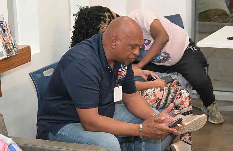 Jefferson County Judge Gerald Robinson scrolls through his phone before election results are announced at his watch party Tuesday, March 31, 2026. (Pine Bluff Commercial/I.C. Murrell)