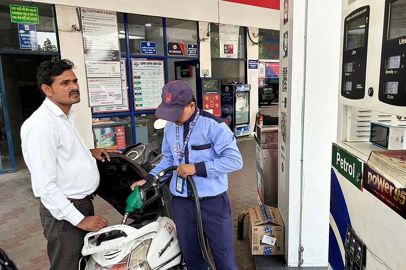 A commuter monitors the meter as an attendant refuels his scooter at a filling station in New Delhi, India, Friday, May 15, 2026. (AP Photo/Shonal Ganguly)