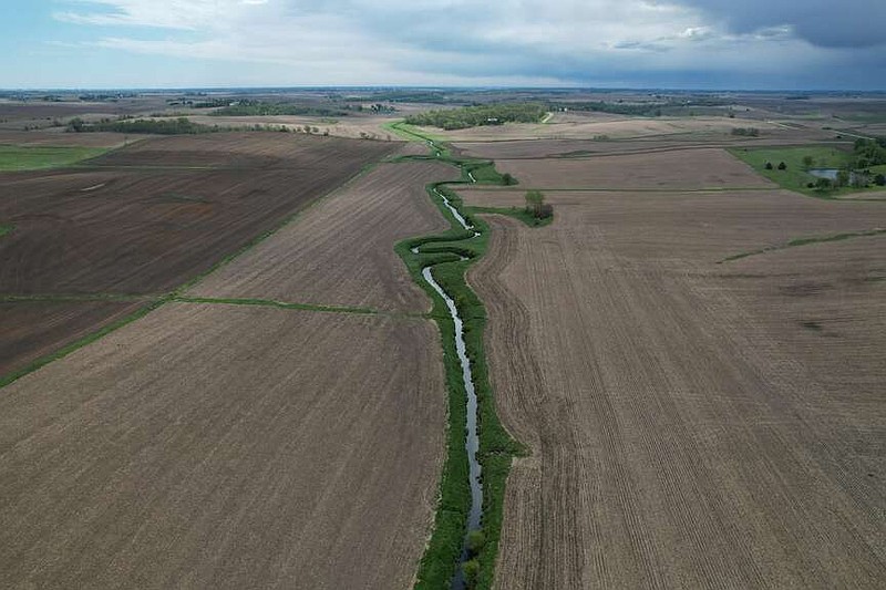 A stream cuts through a farm field Thursday, May 7, 2026, near Marshalltown, Iowa. (AP Photo/Brittany Peterson)
