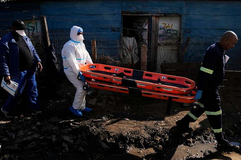Police officers carry a stretcher after a mass shooting in an informal settlement in the Cleveland suburb of Johannesburg, South Africa, on Wednesday, June 10, 2026. (AP Photo/Themba Hedebe)