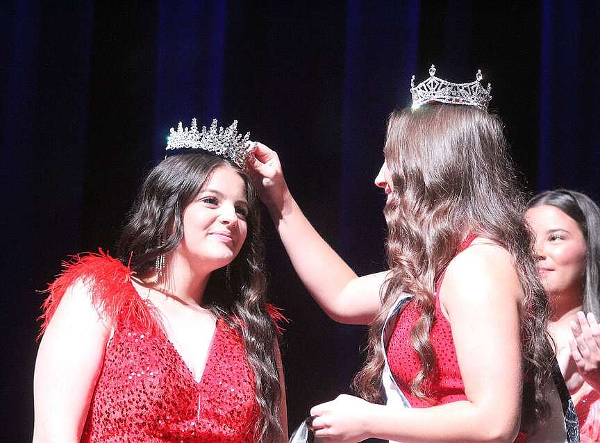 Pageant contestants smile, wave, twirl on stage