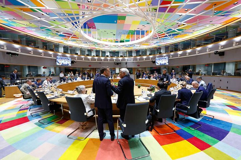 European Council President Antonio Costa, right, talks to French President Emmanuel Macron during a round table meeting at the EU summit in Brussels, Friday, June 19, 2026. (AP Photo/Geert Vanden Wijngaert)