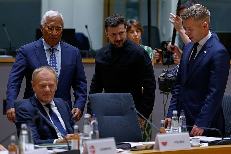 Ukraine's President Volodymyr Zelenskyy, second right, greets Hungary's Prime Minister Peter Magyar, right, next to European Council President Antonio Costa during a round table meeting at the EU summit in Brussels, Thursday, June 18, 2026. (AP Photo/Geert Vanden Wijngaert, Pool)