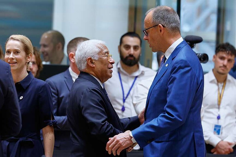 Germany's Chancellor Friedrich Merz, right, talks to European Council President Antonio Costa during a round table meeting at the EU summit in Brussels, Friday, June 19, 2026. (AP Photo/Geert Vanden Wijngaert)