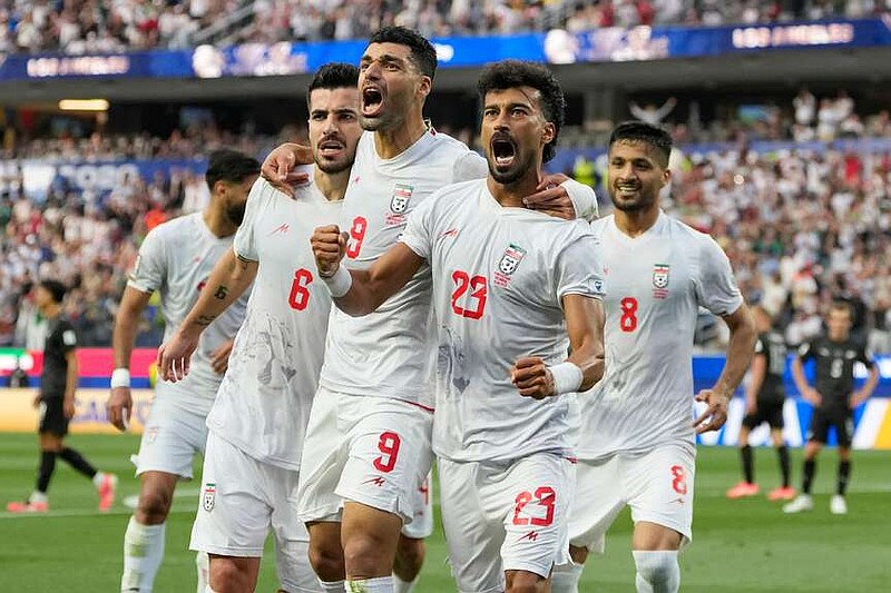 Iran's Ramin Rezaeian (23) celebrates with his teammates after scoring a goal during the World Cup Group G soccer match between Iran and New Zealand in Inglewood, Calif., near Los Angeles, Monday, June 15, 2026. (AP Photo/Andre Penner)