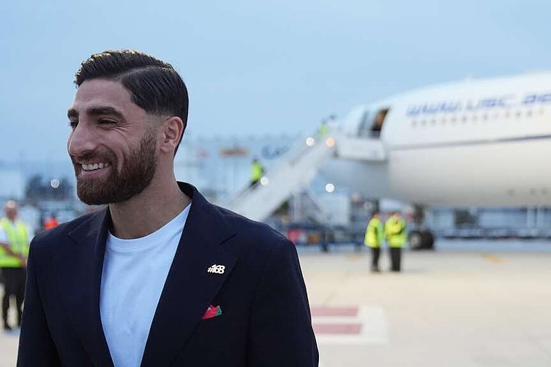 Iran's Alireza Jahanbakhsh smiles as he arrives with his teammates for the World Cup soccer tournament in Tijuana, Mexico, Sunday, June 7, 2026. (AP Photo/Gregory Bull)