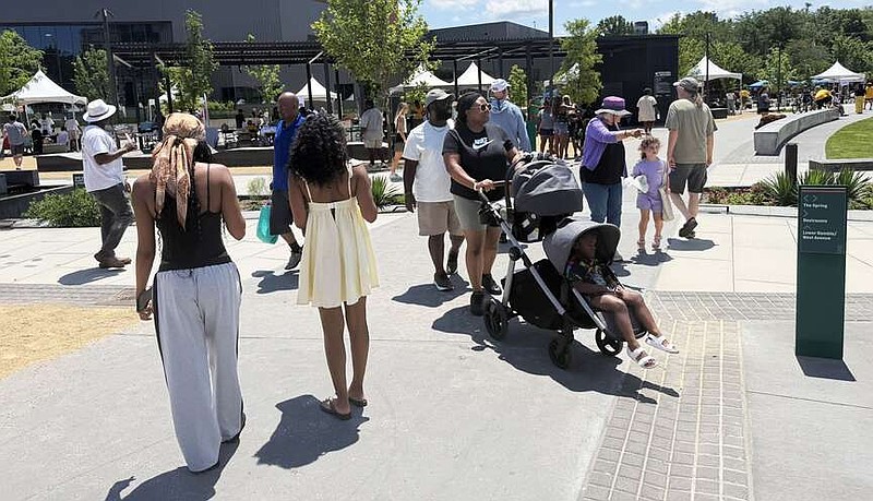 People check out the vendor fair Saturday June 20, 2026 during the Juneteenth celebrations hosted by the University of Arkansas and the NWA Juneteenth Planning Committee in the Upper Ramble in Fayetteville. The free community event featured live music, games, giveaways, and family-friendly activities. Visit nwaonline.com/photo for today's photo gallery. (NWA Democrat-Gazette/J.T. Wampler)