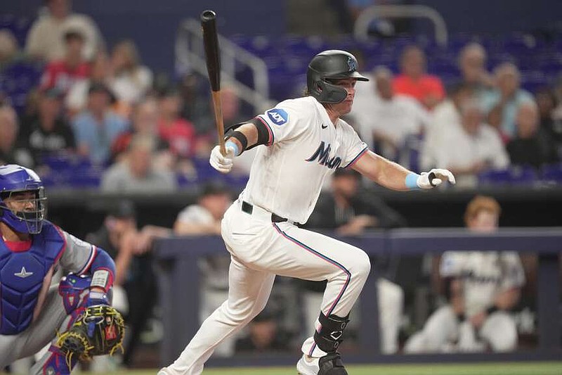 Miami Marlins designated hitter Griffin Conine (18) hits an RBI double against the Texas Rangers in the fourth inning of a baseball game, Wednesday, June 24, 2026, in Miami. (AP Photo/Jim Rassol)