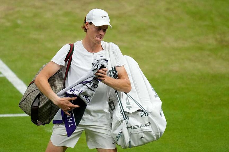 FILE - Italy's Jannik Sinner leaves the court after losing to Serbia's Novak Djokovic in their men's singles semifinal match on day twelve of the Wimbledon tennis championships in London on July 14, 2023. (AP Photo/Kirsty Wigglesworth, File)