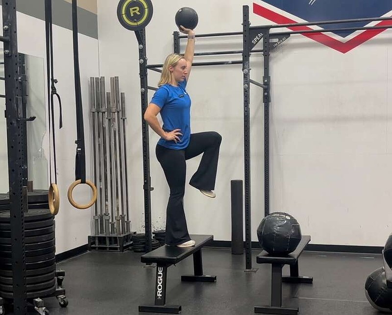 In this third of three photos, Sophia Murombe, personal trainer with the Little Rock Athletic Club, demonstrates the Kong Climb for Matt Parrott's Master Class. (Arkansas Democrat-Gazette/Kimberly Dishongh)