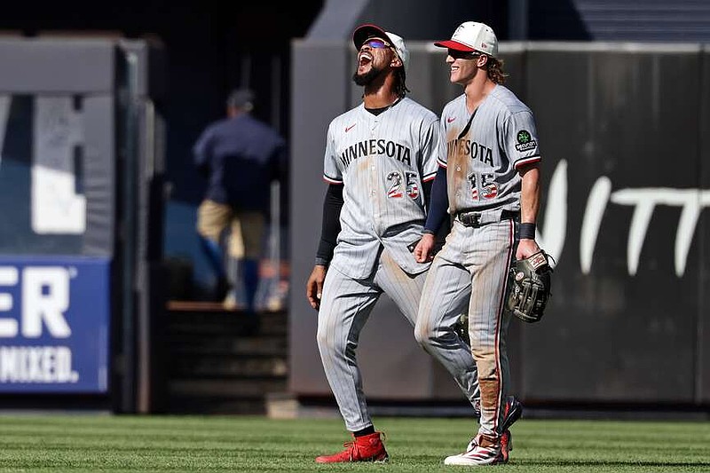Minnesota Twins center fielder Byron Buxton (25) and Luke Keaschall (15) react after defeating the New York Yankees in a baseball game Saturday, July 4, 2026, in New York. (AP Photo/Adam Hunger)