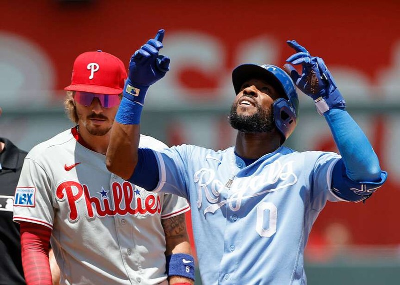 Kansas City Royals' Starling Marte (0) reacts next to Philadelphia Phillies second baseman Bryson Stott (5) after hitting a RBI double during the first inning of a baseball game in Kansas City, Mo., Monday, July 6, 2026. (AP Photo/Colin E. Braley)