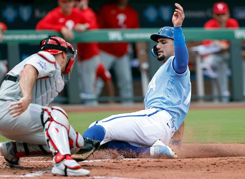 Kansas City Royals' Jac Caglianone, right, beats the tag by Philadelphia Phillies catcher J.T. Realmuto to score off a Nick Loftin double during the first inning of a baseball game in Kansas City, Mo., Monday, July 6, 2026. (AP Photo/Colin E. Braley)