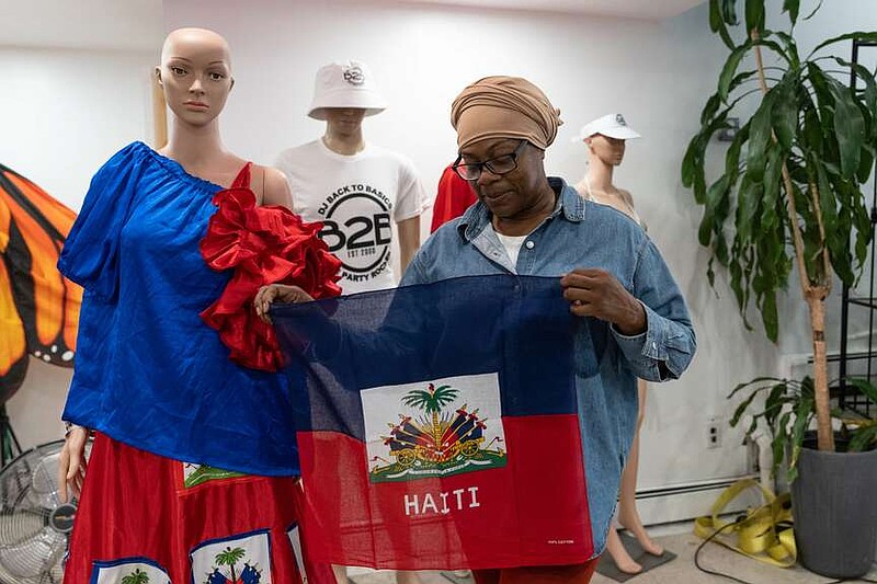 Haitian-born Edwina Paul holds Haitian flag ahead of the West Indian Day Parade, Thursday, Sept. 3, 2026, in the Brooklyn borough of New York. (AP Photo/Adam Gray)