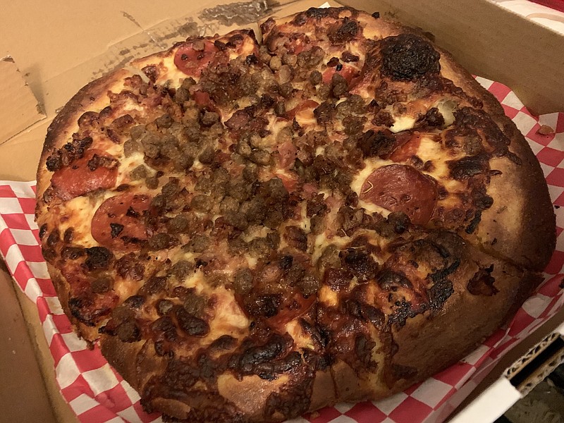 Certified Pies' carnivore-centered Boss Hog pizza — available in 12- and 16-inch sizes — comes topped with pepperoni, two kinds of sausage, beef, bacon, a five-cheese blend and red sauce. (Arkansas Democrat-Gazette/Eric E. Harrison)