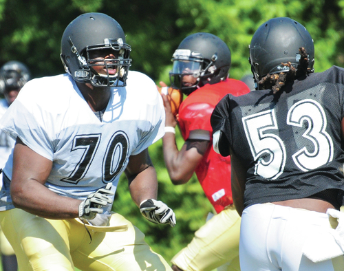 Business as Usual: O-line goes about job without coach hired full-time