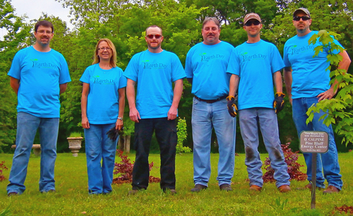 Employees plant shrubs at park for Earth Day
