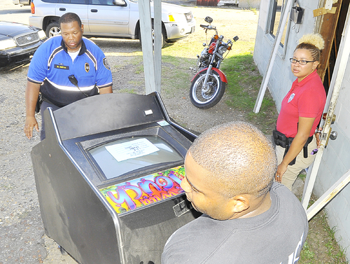 Law enforcement officers serve warrants at video arcades Wednesday