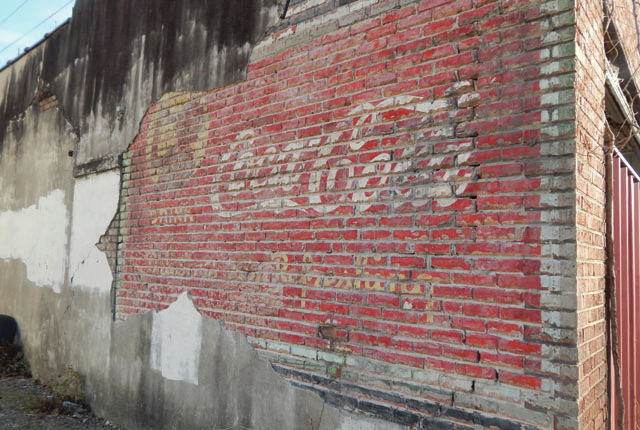 History buffs uncover old Coca-Cola sign at vacant building