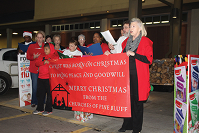 Carolers sing Christmas songs at Pine Bluff businesses