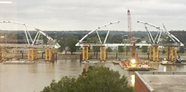 Economic Development Side: As river supporters talk, barges move below