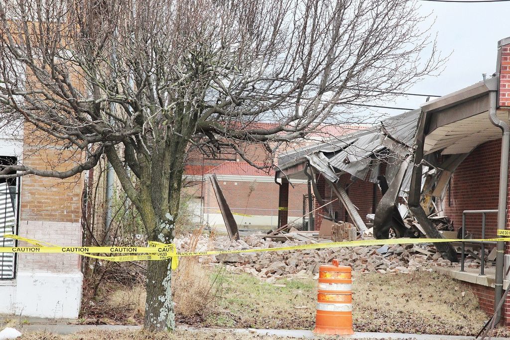 Condemned downtown structure’s wall hits building next door