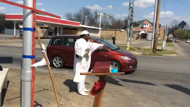 Pastor Larry O. Walker of Little Rock preaches against violence Thursday afternoon at the corner of Cherry and 16th Avenue.
