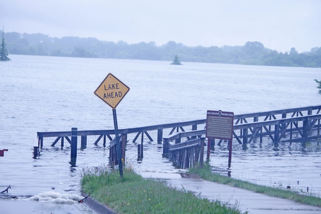 As river climbs to crest, officials watch, hope